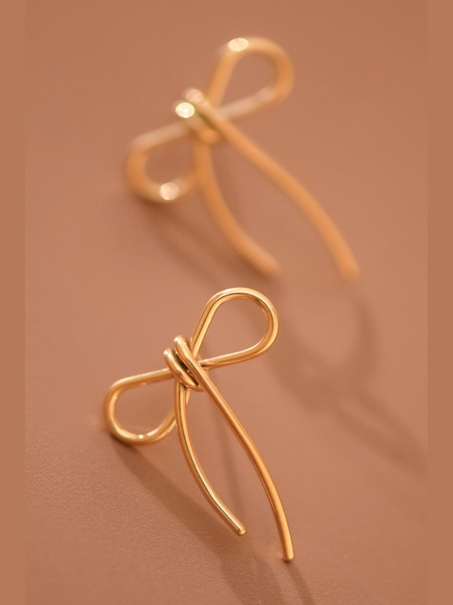 Gold bow drop earrings