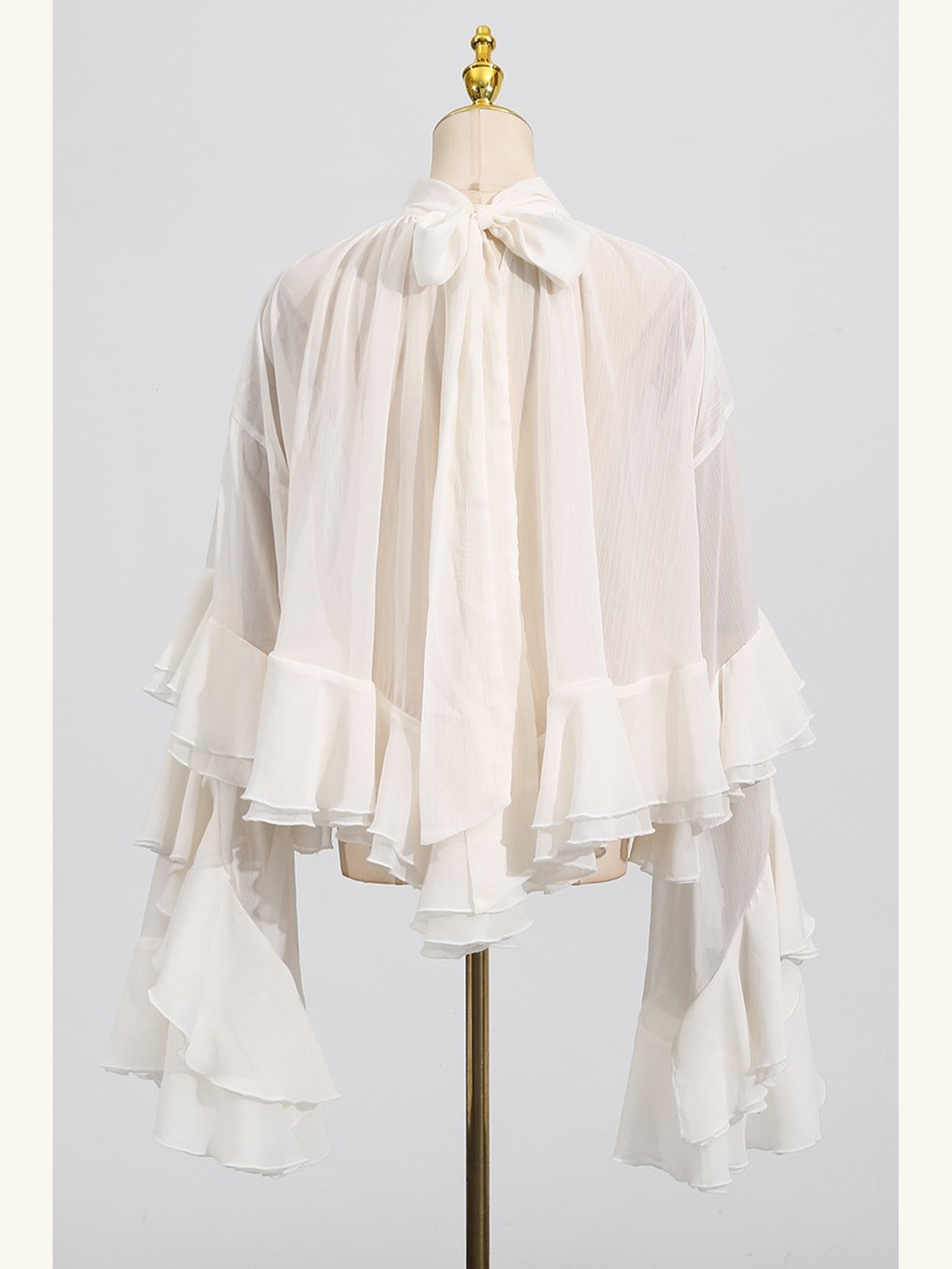 Ruffled sheer mock-neck blouse